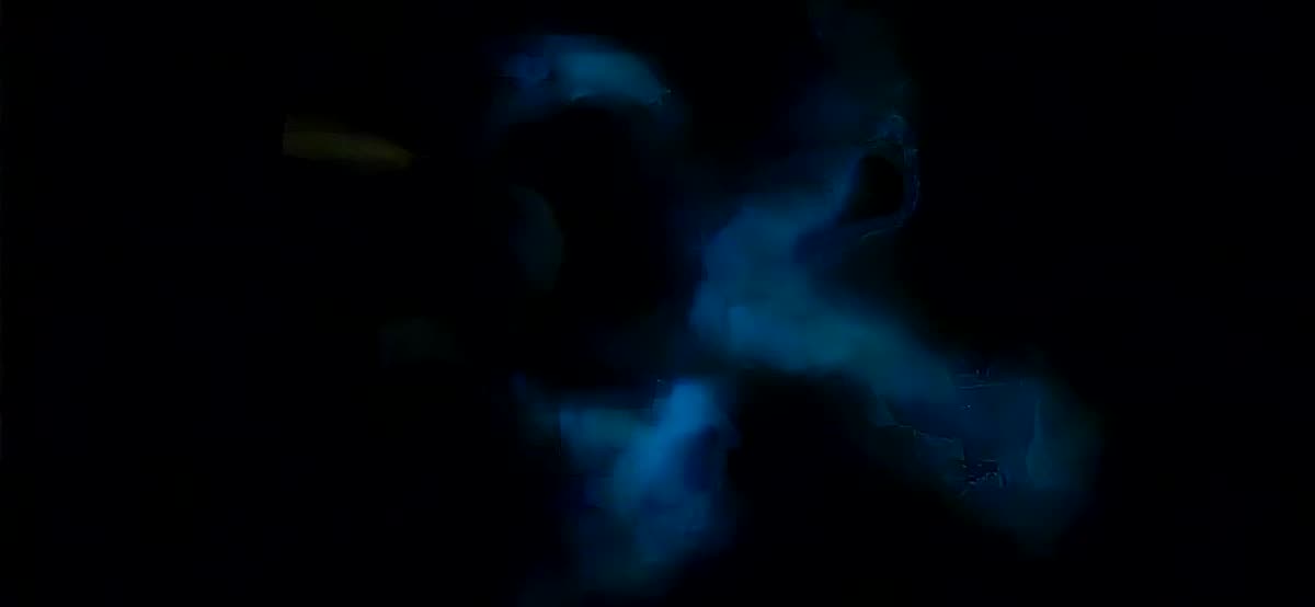 Plankton glowing blue in the black water beside the boat